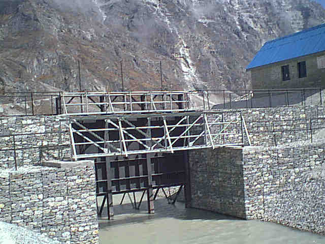 Sluice gate controling flow notch cut in moraine bank of Tsho Rolpa